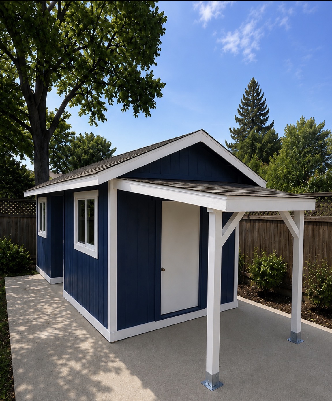Custom navy and white shed with covered porch installed in a Thousand Oaks backyard