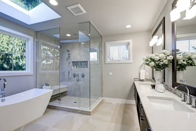 Bathroom remodel in Santa Barbara with glass shower enclosure and freestanding tub